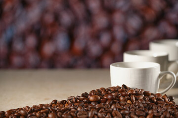 Three cups of coffee on the marble table. Coffee beans on the table, blurred background. Close- up