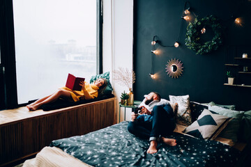 Young couple relaxing in decorated bedroom