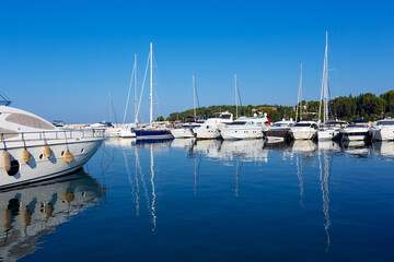 Fototapeta premium sailboats moored at the pier in harbour of Rovinj town, Croatia.
