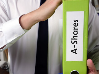  Financial concept meaning A-Shares with phrase on the piece of paper.