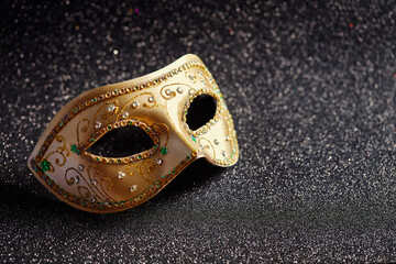 Festive, colorful Mardi Gras or carnivale mask on glitter black background. Venetian masks. Party invitation, greeting card, venetian carnivale celebration concept.