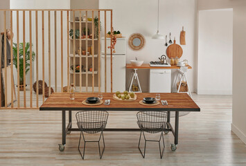 Dining room and working table in front of the decorative kitchen style, refrigerator, dishwasher...