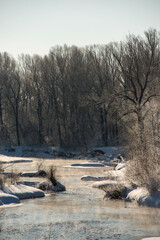 winter is not a frozen river, and around the trees in white frost