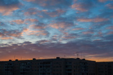 very colorful sunset over a multi-storey building in the city of Orenburg