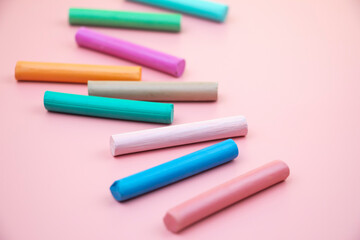 colorful crayons on a pink background