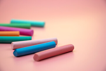 lots of colorful crayons on a pink background