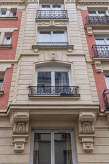 Old French house with traditional balconies and windows. Paris, France.
