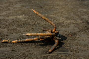 Rusty anchor on a wet beach at Bakkhali.