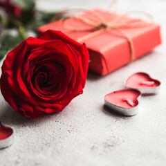 Valentine's Day, Gift box with a ribbon, candles and rose.