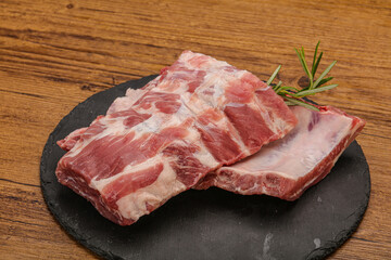 Raw pork ribs served rosemary