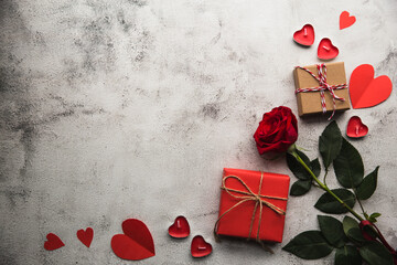 Valentine's Day, Gift box with a ribbon, candles and paper hearts. - 405449988
