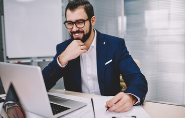 Fototapeta premium Cheerful businessman working in office