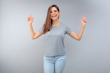 Smiling woman wearing casual pointing fingers up.