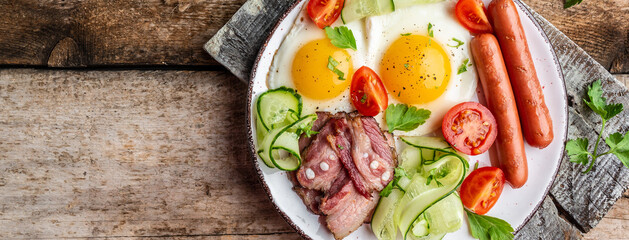 English breakfast fried egg, beans, tomatoes, bacon and coffee. Delicious breakfast or lunch. Top view, banner, overhead