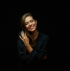 Smiling woman with big smile and closed eyes wearing black dress