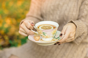 woman holding a cup of tea in her hands