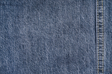 Jeans background, denim with seam of fashion design, place for text. Top view.