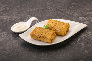 Staffed pancakes served sour cream