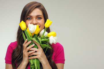 smiling girl in red dress holding yellow and white tulips.