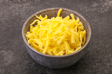 Shredded yellow cheese in the bowl
