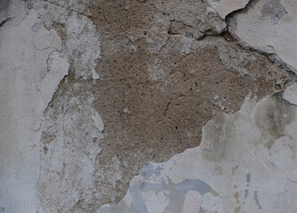Textured background of an old wall made of beige plaster. Smooth surface. Cracks. Copy space. Old peeling plaster wall, crumbles.
