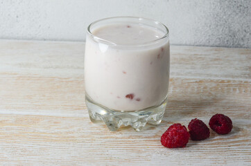 Fresh homemade yogurt with berries, fermented milk products with raspberries, bifidobacteria and a healthy breakfast drink