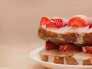 Pastries with red berries and white cream. Cake with strawberries and sour cream. Close-up. Food. Copy space. Selective focus.