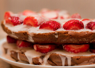 Pastries with red berries and white cream. Cake with strawberries and sour cream. Close-up. Food. Copy space. Selective focus.