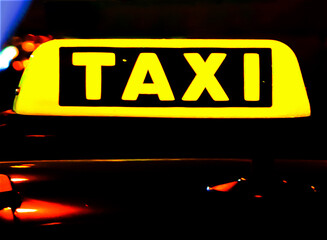 Taxi in the city at the dark. Car with glowing taxi sign moving in the night