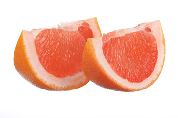 two juicy, fresh grapefruit slices on a white isolated background