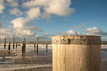 Naklejka na ściany i meble Wooden poles at the beach of Petten, Holland.