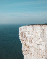 White Chalk Cliff Edge Over Blue Sea
