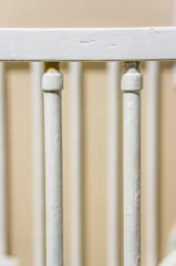 Vertical closeup of baby cradle white handrails