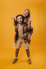 Young happy couple playing together piggyback