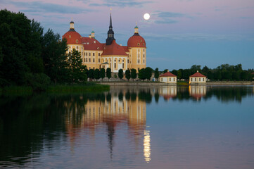 Fototapeta na wymiar Hunting Castle Moritzburg Near Dresden With Full Moon And Reflections In The Pond