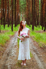 Obraz na płótnie Canvas Outdoor portrait of young redhead woman in vintage wedding dress with big bouquet of pink peonies. Woman's Day. Female spring, summer fashion concept. Wedding day.