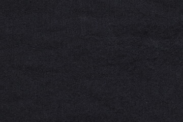 Naklejka na ściany i meble The texture of the black fabric for clothing.