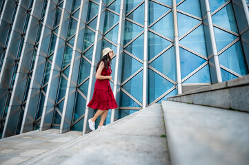 Asian woman in red dress at modern building, female girl with urban city lifestyle