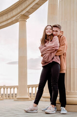 Young loving couple embracing each other outdoors in the park