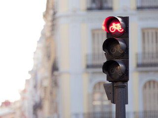 Red Traffic Light. Bicycle stop on road. Blurred background.