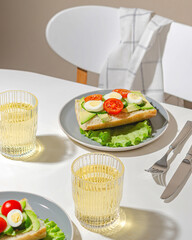 A beautiful serving of a sandwich with vegetables and avocado. Vegetarian breakfast.