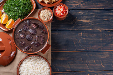 Typical Brazilian dish called Feijoada. Made with black beans, pork and sausage. Top view. Copy space