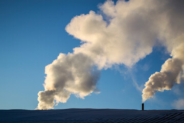 Smoke from the chimney in frosty winter.