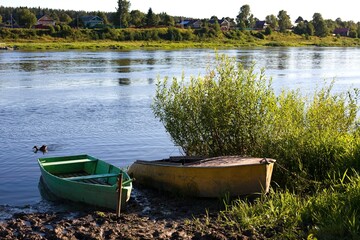 Two old fishing boats with on river Sukhona, Totma, Russia