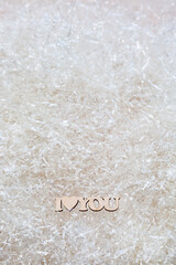 The phrase I love you made of wood on a light background with copy space. Minimalistic valentine's day concept