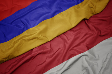 waving colorful flag of indonesia and national flag of armenia.