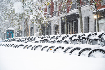 bicycles in the street of madrid covered with snow. Borrasca Filomena.Madrid.Spain