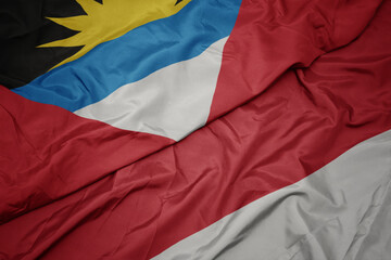 waving colorful flag of indonesia and national flag of antigua and barbuda.