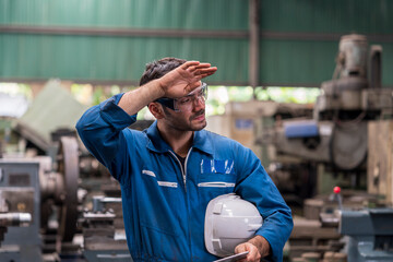 Technicians are exhausted from working on industrial machines.