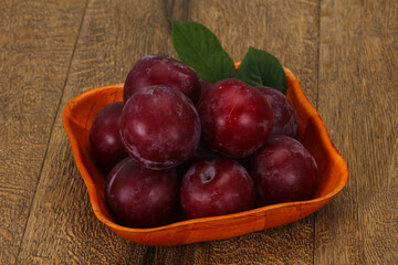 Plum heap in the wooden basket